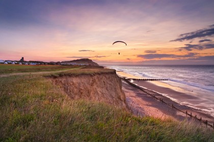 Paragliders on the Norfolk coast at sunset